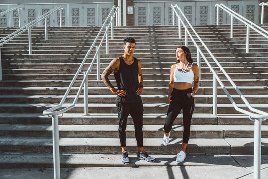 Man and woman outside in workout gear - Workout
