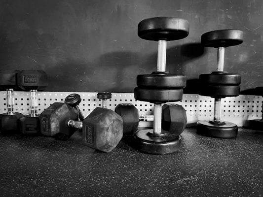 2 black dumbbells on black surface