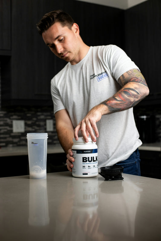 a man is holding a can of bullet