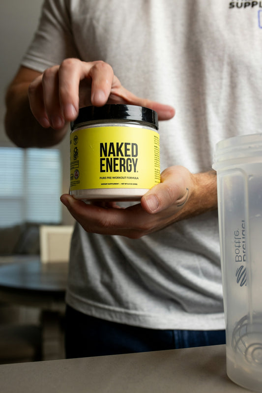 a man holding a jar of naked energy