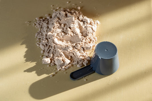 Pile of protein powder with a scoop