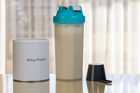 Whey protein container and shaker bottle with drink