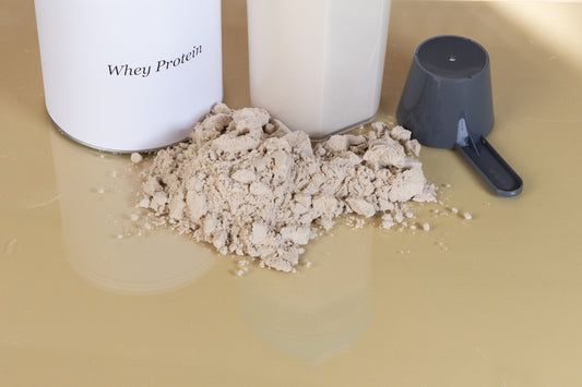 Whey protein powder with a scoop and container